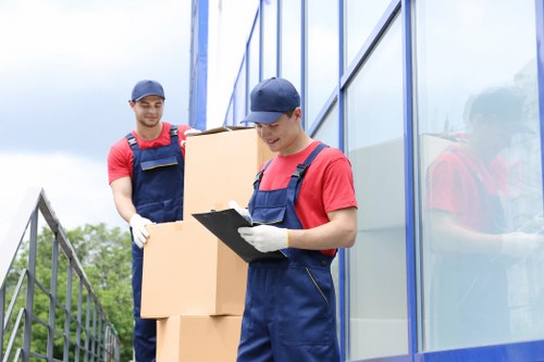Moving boxes and furniture during an office relocation in Clapton