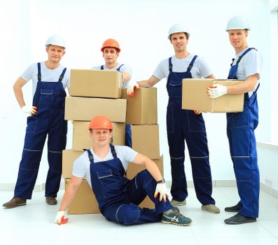Team member using PPE while loading furniture into a van