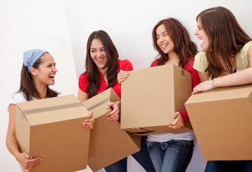 Packed moving boxes and furniture ready for transport in Clapton