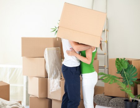 Professional moving helper carrying items for a flat move in Clapton