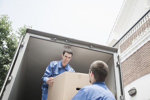 Packed moving boxes and furniture ready for a house removal in Clapton
