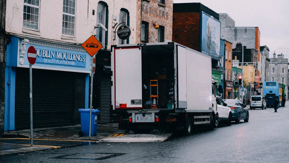 The image shows two adjacent loading bays at a warehouse or industrial building, numbered 5 and 6, with partially open metal shutters revealing interior storage areas containing cardboard boxes and ot